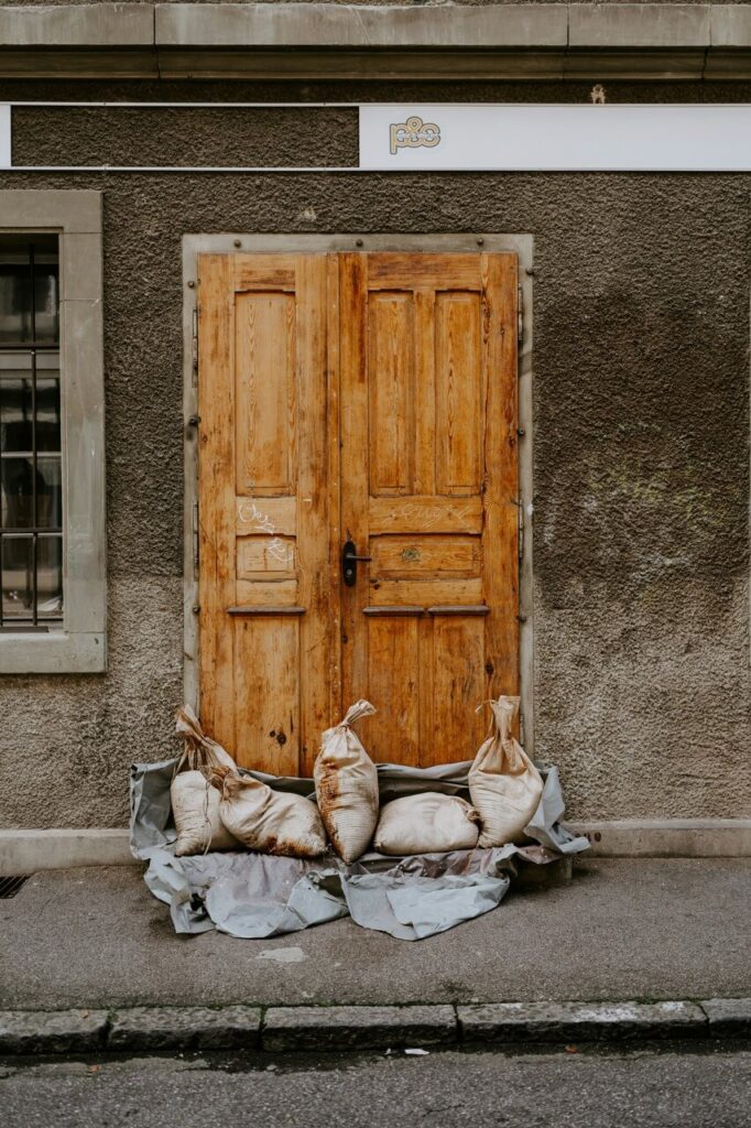 Doorway to restaurant, closed and sandbagged due to flooding
